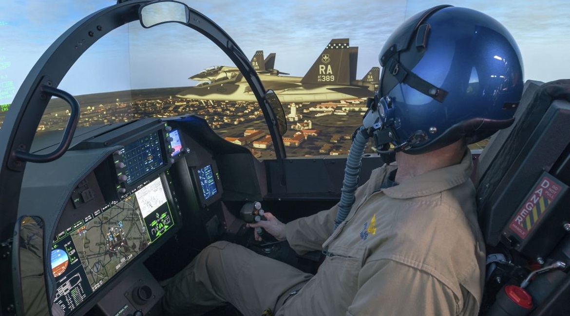 A Boeing test pilot operating the company's T-7A representative operational flight trainer (OFT). The OFT has a five-channel projection system with a 300° field-of-view.