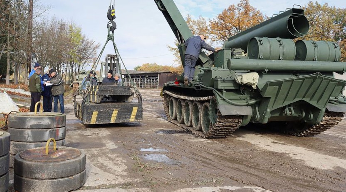 The vehicle is shown demonstrating the lift capacity of its modernised crane.