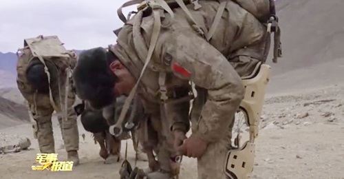 A still from CCTV footage released on 9 December showing members of a PLAGF patrol unit in Tibet putting on recently delivered exoskeleton systems.