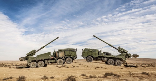 Two versions of the Elbit ATMOS are shown here. The company will also demo its 8×8 version with a semi-automatic loader for the US Army in an upcoming shoot off.