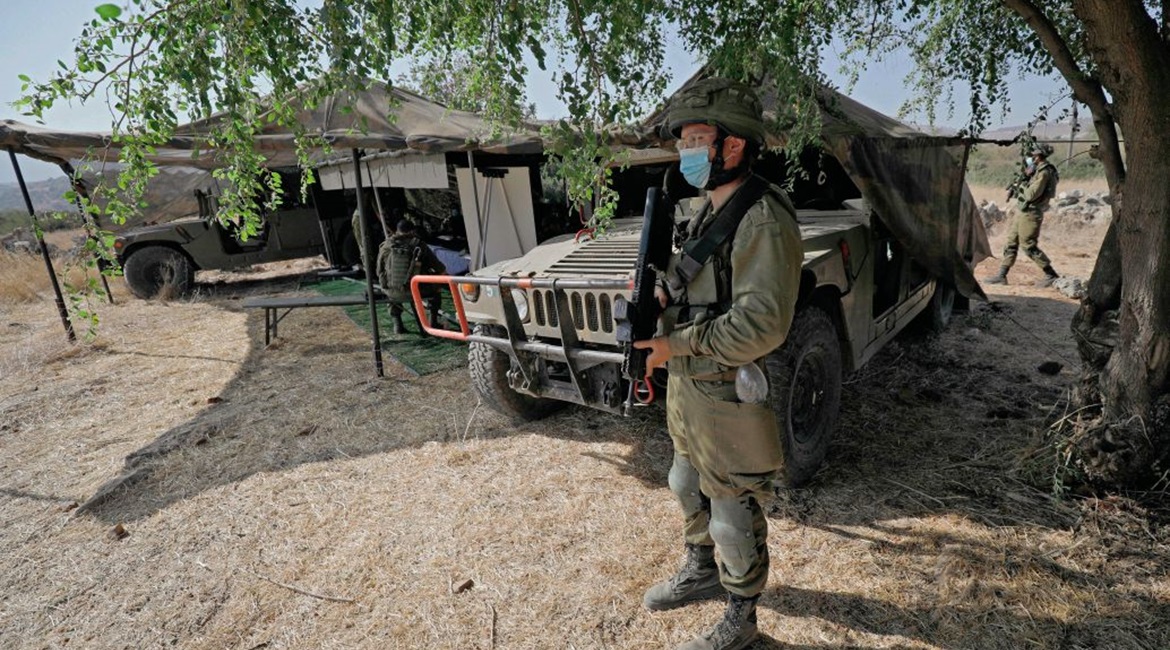 An Israeli soldier stands guard next to an outpost on 27 October 2020 during exercise 'Deadly Arrow' simulating a war against Hizbullah as part of efforts to improve the Israeli military's attack capabilities. The IDF believes that Hizbullah is the num...