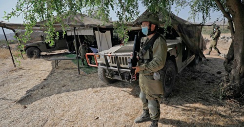 An Israeli soldier stands guard next to an outpost on 27 October 2020 during exercise 'Deadly Arrow' simulating a war against Hizbullah as part of efforts to improve the Israeli military's attack capabilities. The IDF believes that Hizbullah is the num...