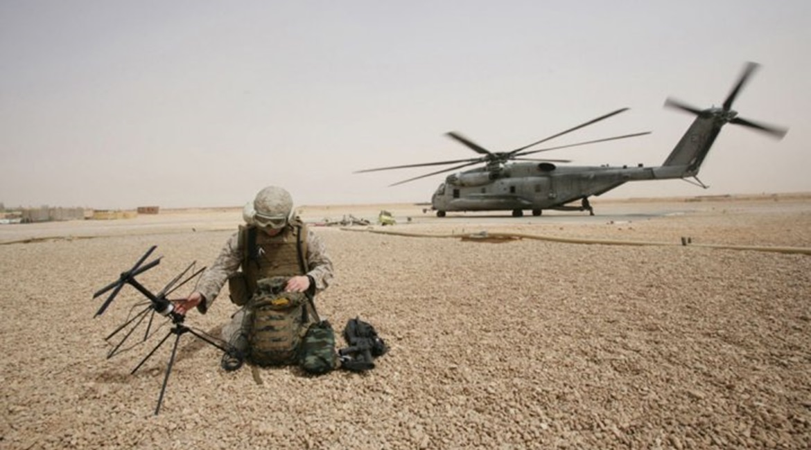 A US Marine Corps field radio operator from the 26th Marine Expeditionary Unit sets up satellite communication at Camp Korean Village, Iraq in 2008.