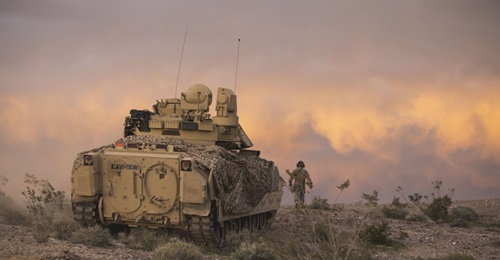 An M2 Bradley fighting vehicle covers dismounted units from 2nd Armored Brigade Combat Team during field exercises at Fort Irwin, California.
