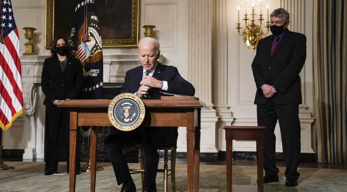 US President Joe Biden signs executive orders at the White House in Washington, DC, on 27 January 2021. The orders included tasks for national security teams to prioritise climate change.