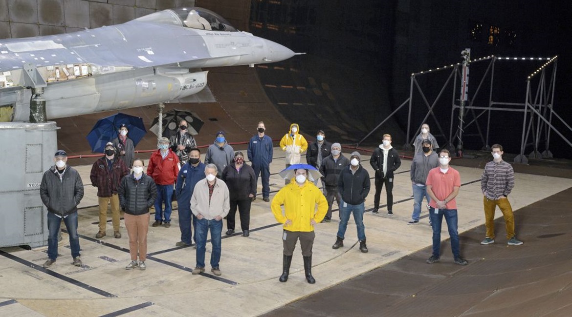The test team for the F-16 canopy water pooling visibility test stand beside the test article in the National Full-Scale Aerodynamics Complex's 12x24 m test section on 1 December 2020. The USAF used the wind tunnel to test how to address rain pooling o...