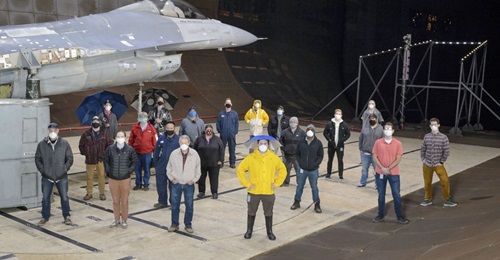 The test team for the F-16 canopy water pooling visibility test stand beside the test article in the National Full-Scale Aerodynamics Complex's 12x24 m test section on 1 December 2020. The USAF used the wind tunnel to test how to address rain pooling o...