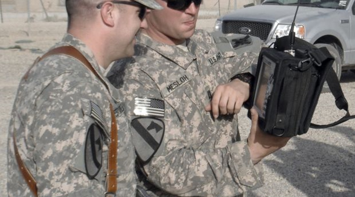 A US Army electronic warfare officer with the 103rd Sustainment Command (Expeditionary) discusses the measurements on a handheld spectrum analyser collected during combat operations in Iraq.