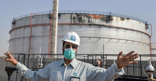An employee at the Saudi Aramco oil facility stands near a silo at a plant in Saudi Arabia's Red Sea city of Jeddah on 24 November 2020. The facility was damaged during an attack the previous day by Yemen-based Houthi militants.