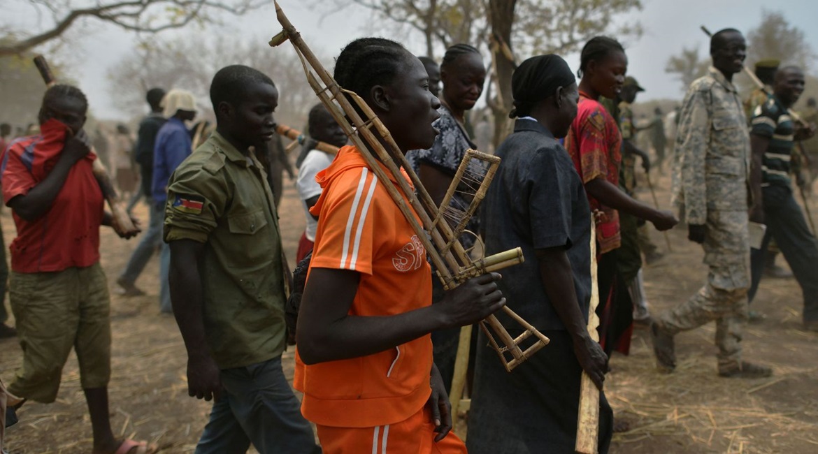 Trainee soldiers for a new unified army carry wooden rifles while attending a reconciliation programme run by the UN Mission in South Sudan (UNMISS) at a makeshift barracks in Mapel in January 2020. The South Sudanese armed forces are being plagued by ...