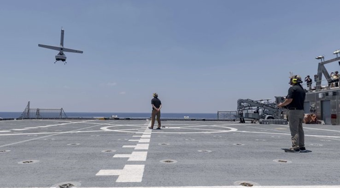 A Martin UAV V-Bat VTOL unmanned aircraft prepares to land on the flight deck of the Military Sealift Command's Spearhead-class catamaran expeditionary fast transport vessel USNS 
        
         (T-EPF 1) on 24 July 2019. The V-Bat's abilit...