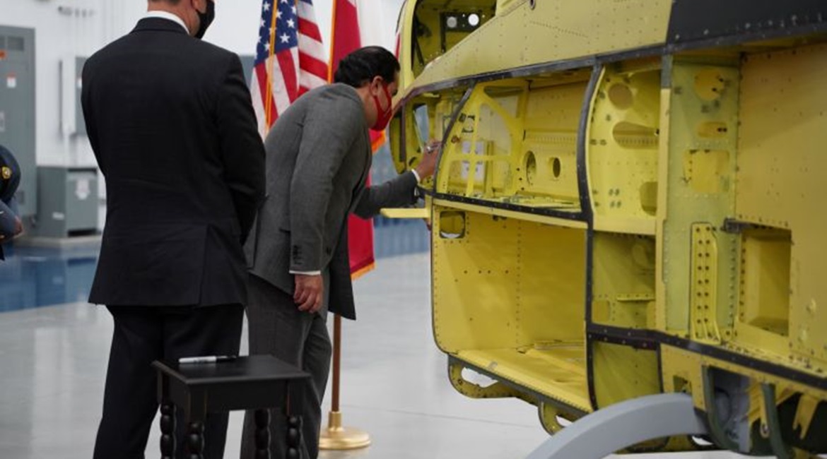 Bahrain Ambassador to United States, Shaikh Abdulla Al Khalifa, signs the first of 12 AH-1Z attack helicopters for the Royal Bahraini Air Force during a visit to Bell's Amarillo production plant in Texas.
