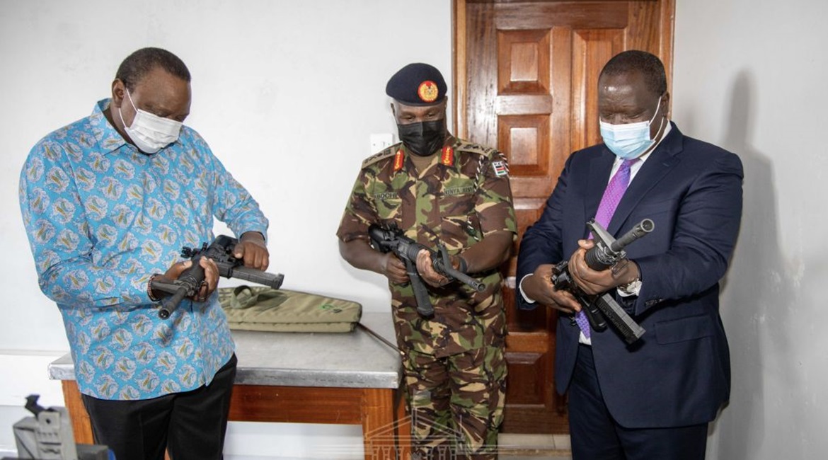 President Kenyatta (left) inspects one of the rifles produced by the new Small Arms Factory.