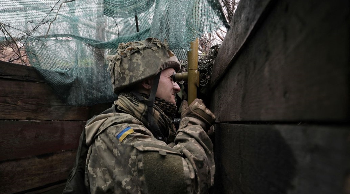A Ukrainian soldier uses a periscope on the front line with Russian-backed separatists near Marinka, Donetsk, on 20 April.