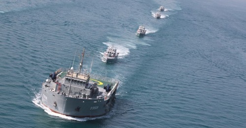 The Kuwait Naval Force's uses the oil rig replenishment and accommodation ship 
        
         (foreground) as an auxiliary transport vessel.