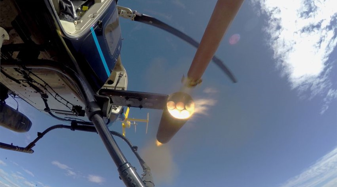 A Thales FZ90 70 mm/2.75” rocket motor body is fired from an Arnold Defense M260 air launcher mounted on a Bell 407 utility helicopter during qualification tests at Dillon Aero's test range near Maricopa, Arizona in January.