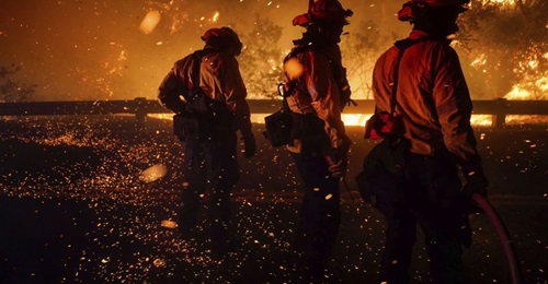 Firefighters tackle a fire in vegetation in Silverado, California, on 3 December 2020. Climate change is increasing in prevalence in national security and intelligence assessments.