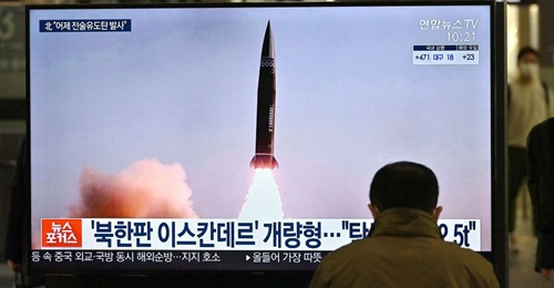 News footage of North Korea's latest SRBM test launch shown on a TV screen at Suseo railway station in Seoul on 26 March. South Korea has revised its assessment of the distance travelled by the two SRBMs test-launched by Pyongyang on 25 March, saying t...