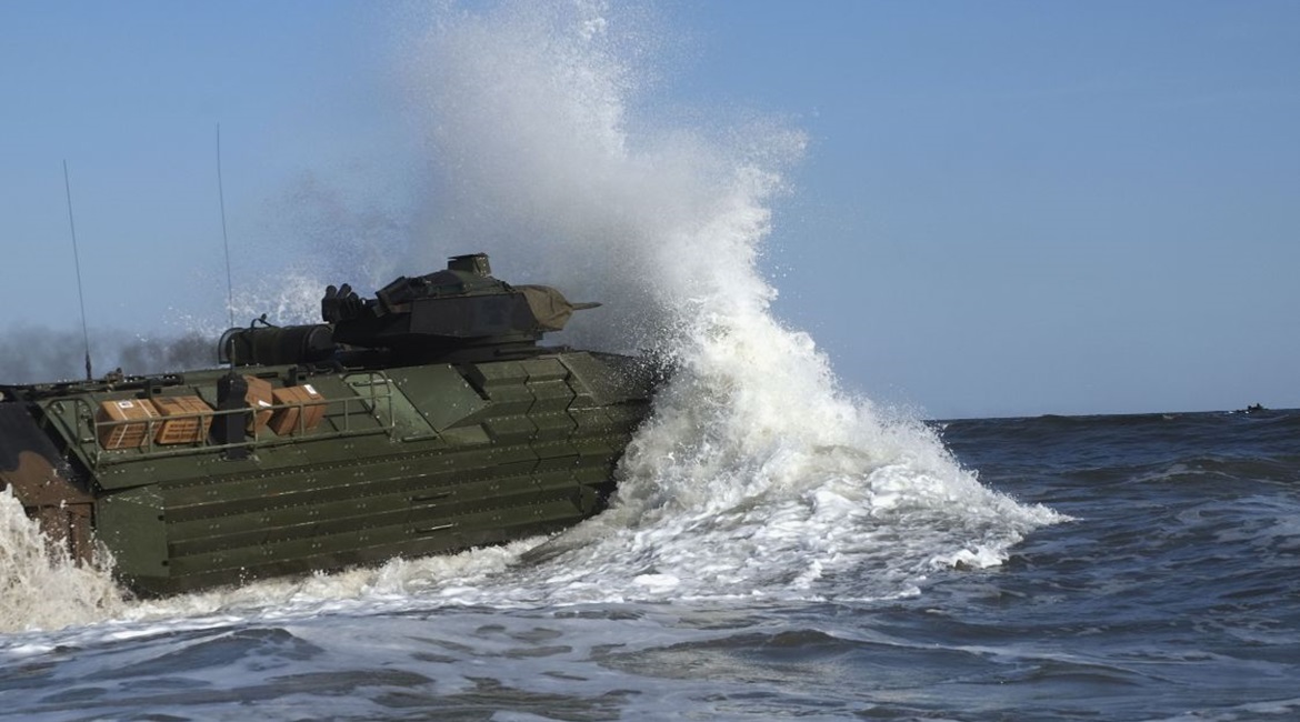 An AAV7 amphibious assault vehicle with the 24th Marine Expeditionary Unit enters the water at Camp Lejeune on 3 October 2018 to embark on USS 
        
         (LPD 21) in preparation for Exercise 'Trident Juncture 2018'.
