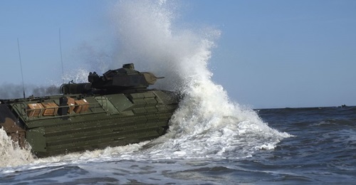 An AAV7 amphibious assault vehicle with the 24th Marine Expeditionary Unit enters the water at Camp Lejeune on 3 October 2018 to embark on USS 
        
         (LPD 21) in preparation for Exercise 'Trident Juncture 2018'.