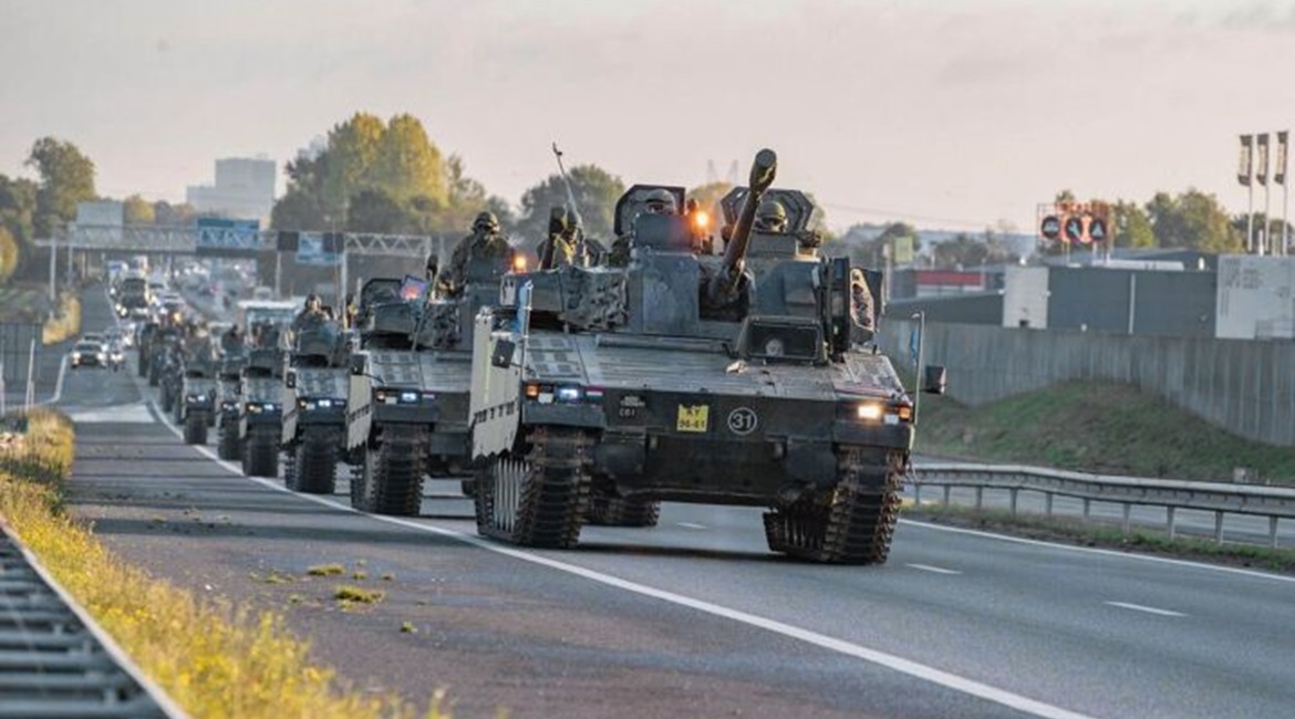 The Dutch Ministry of Defence has worked with civil authorities to create three multimodal corridors of infrastructure for military movements across the Netherlands: road (photo of CV90 infantry fighting vehicles moving by highway), rail, and inland wa...