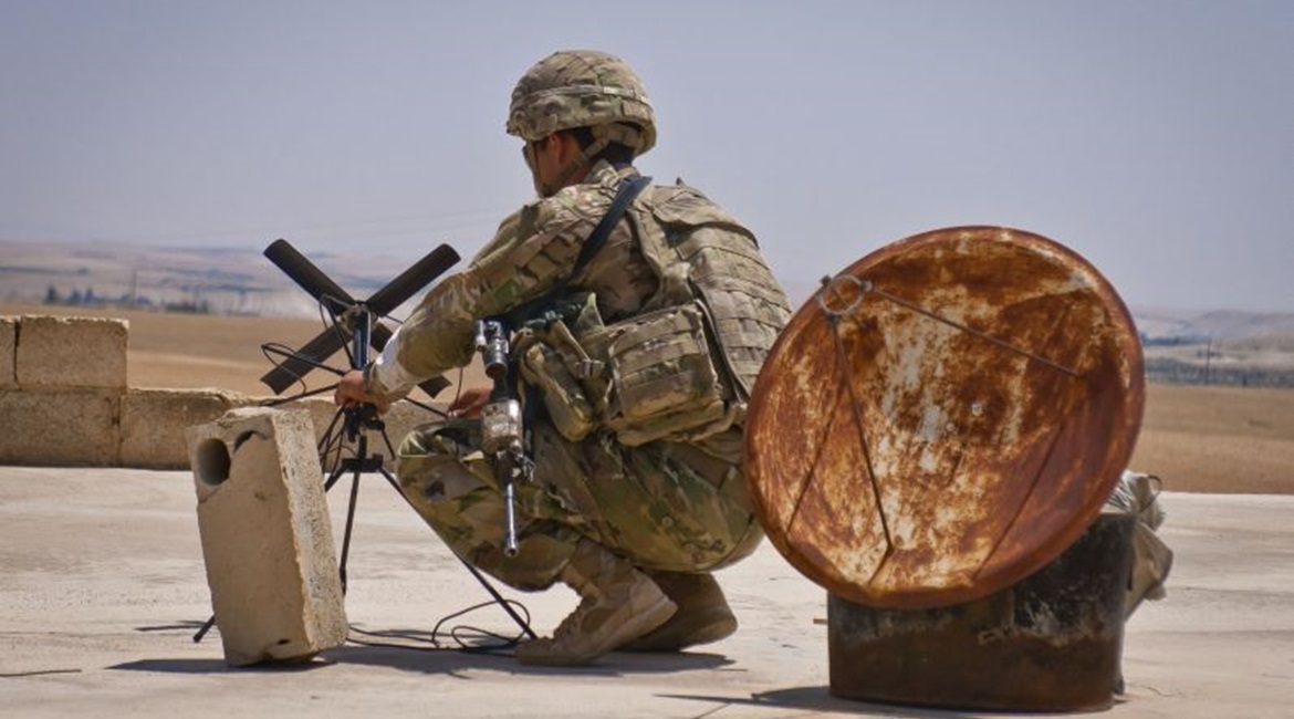 A US soldier sets up an antenna during a co-ordinated patrol with the Turkish military forces along the demarcation line outside Manbij, Syria.